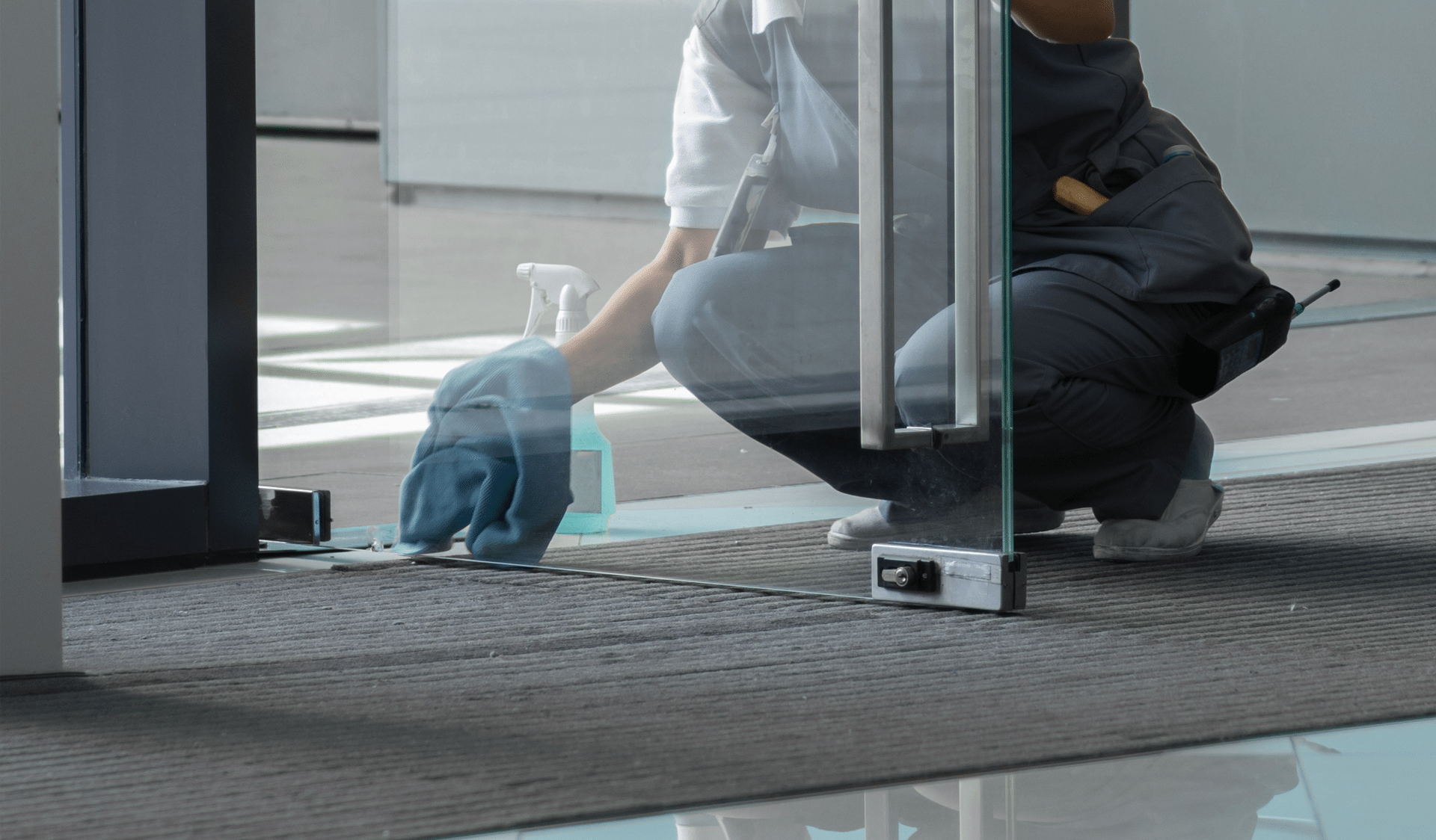 Glass door being wiped down by a professional